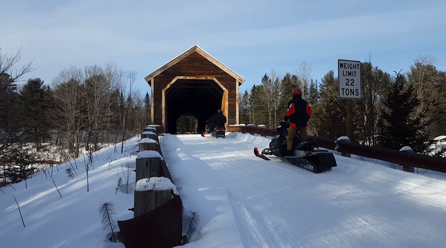 Snowmobiling through Low's Covered Bridge on ITS 85 in Maine